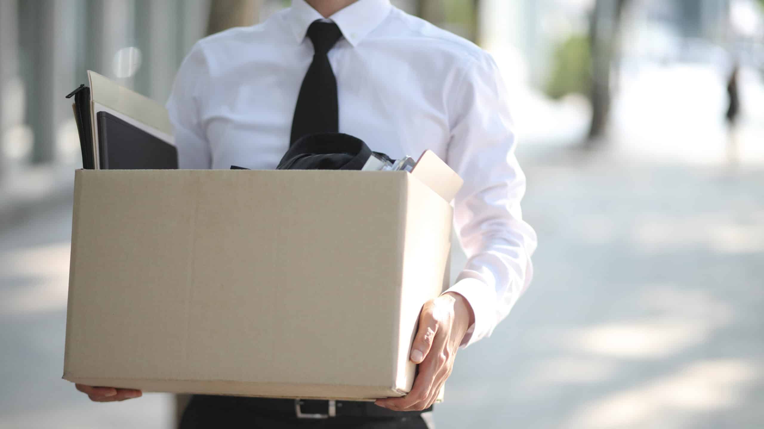Close-up Of Unemployed Businessperson Carrying Cardboard Box